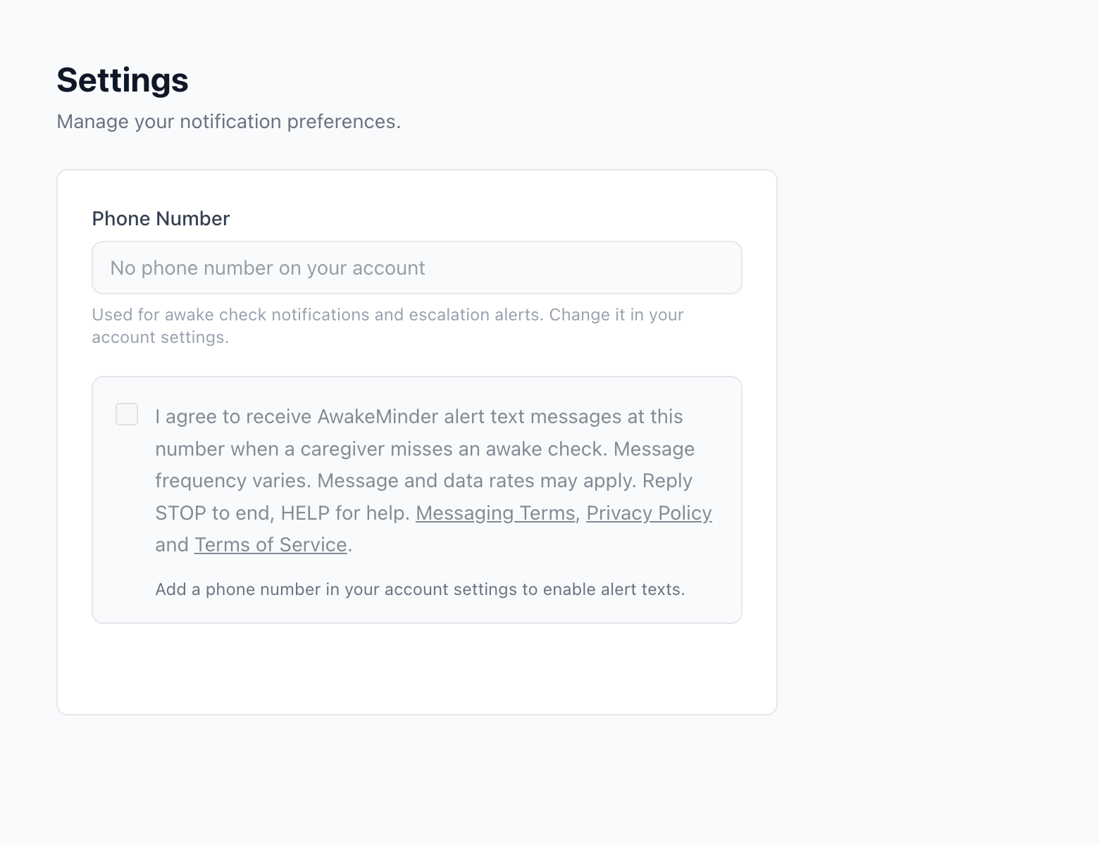 The AwakeMinder settings screen with an empty phone number field. The consent box is greyed out and cannot be ticked, with helper text reading: Enter a phone number above to enable alert texts.